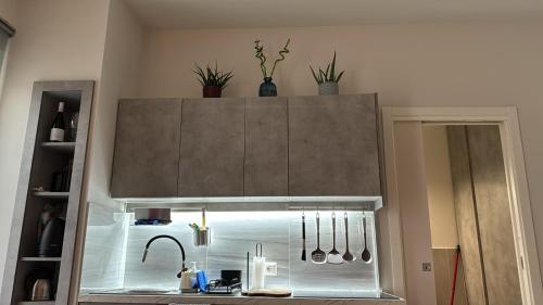 a kitchen with a counter top with utensils at R-HOME Acicastello in Aci Castello