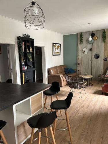 a living room with a table and chairs and a couch at Madras in Sète