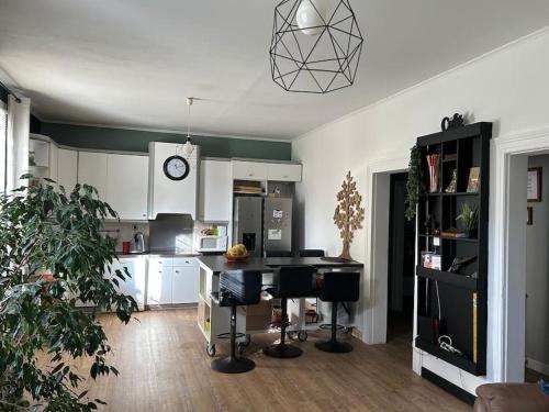 a kitchen with white cabinets and a table and chairs at Madras in Sète