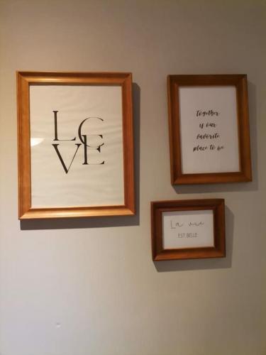 two picture frames on a wall with writing on it at Madras in Sète