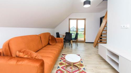 a living room with a couch and a table at Dom Gościnny 2 Ogrodowa in Wiślinka