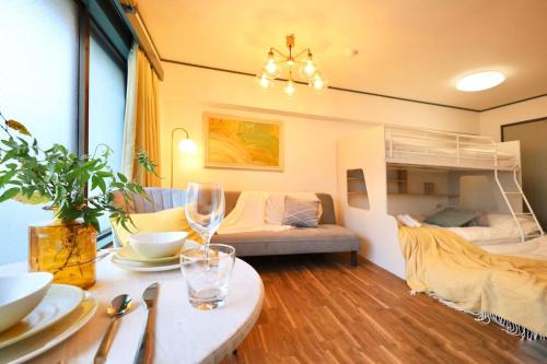 a living room with a table and a bunk bed at スターハイツ蒲田 in Tokyo