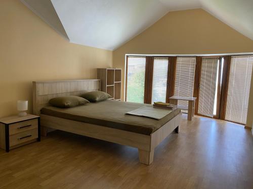 a bedroom with a bed and a large window at Veranda Guest House in Chornomorsk