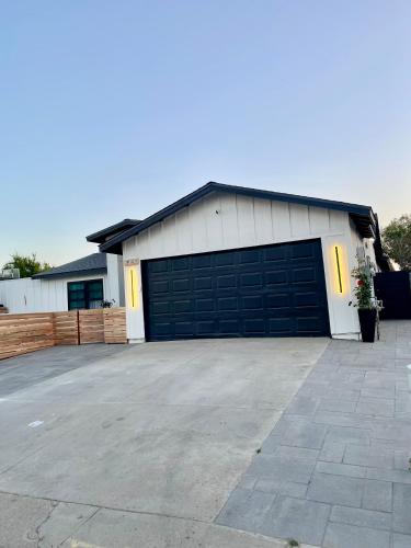 a garage with a large parking lot in front of it at Newly Built, Bright, and Modern Guest Home in San Diego