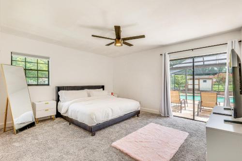 a bedroom with a bed and a ceiling fan at Modern Wimauma Family Home with Private Pool and Yard! in Sun City Center