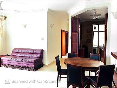 a living room with a table and a couch at Two bed room apartment with sea view in Watumulla
