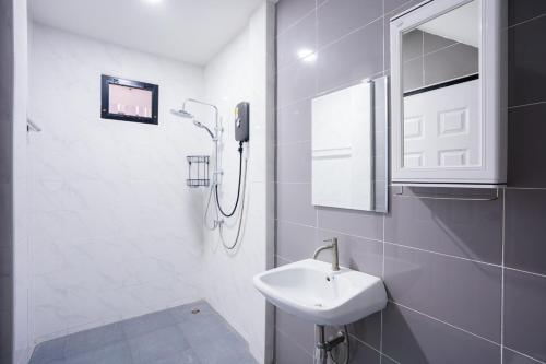 a white bathroom with a sink and a shower at The Moment Pool Villa Bangsaray in Bang Sare