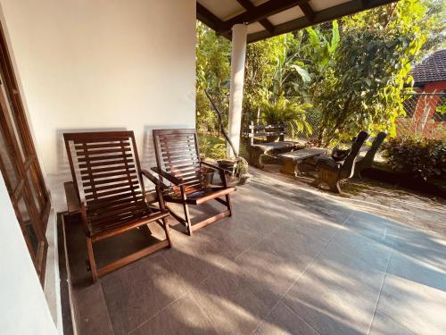 two chairs sitting on the porch of a house at The Grandiose Safari in Udawalawe