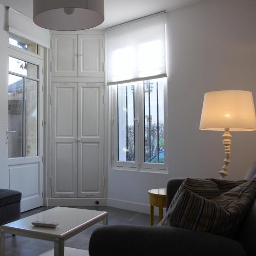a living room with a couch and a table at Les Hauts du Plateau in Châtillon