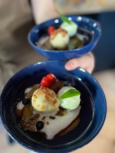 two blue bowls of food with fruit and cream at Gasthaus Schwanen & Villa Pfarrhus in Stühlingen