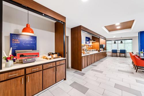 Una zona de espera en un restaurante con un mostrador y sillas. en Holiday Inn Express & Suites Sylva / Dillsboro by IHG, en Dillsboro