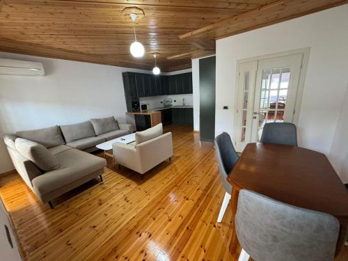 a living room with a table and a couch at Central Apartment Gjirokaster in Gjirokastër