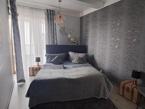 a bedroom with a bed with a blue head board at Apartament -Sweet Home in Lubin