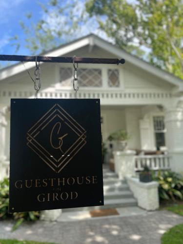 a sign hanging in front of a house at Guesthouse on Girod in Mandeville