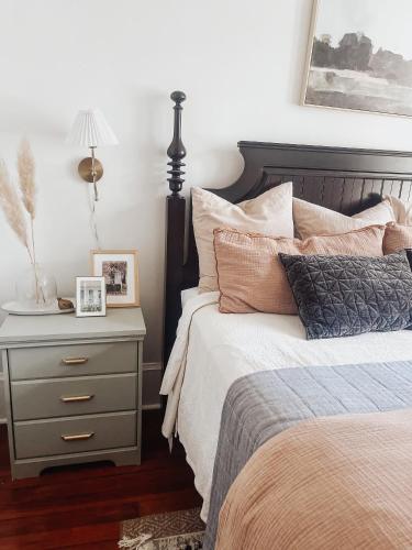 a bedroom with a bed and a nightstand with a lamp at Guesthouse on Girod in Mandeville