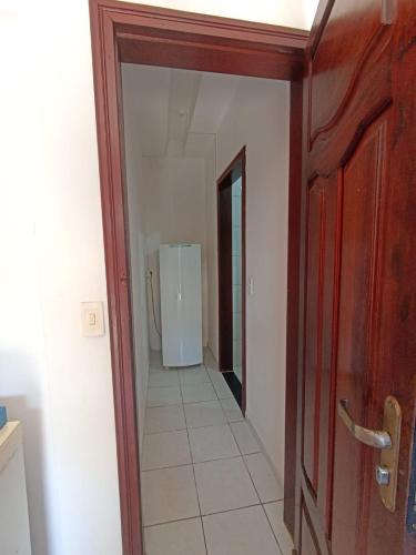 a hallway with a door and a refrigerator in a room at Ponta Negra Suites & Apart in Natal