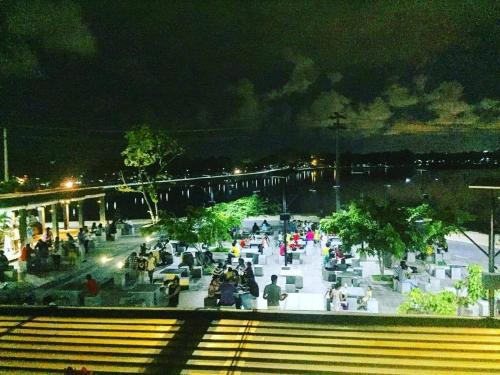 a crowd of people sitting in a plaza at night at Amaze Residence luxury 2bedroom apartment 2 in Boralesgamuwa