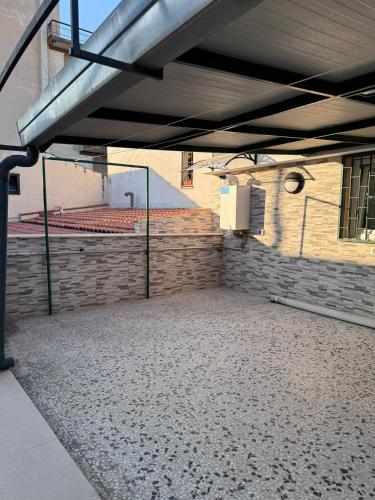 an empty parking lot in a building with a brick wall at Moonlight B&B in Canosa di Puglia