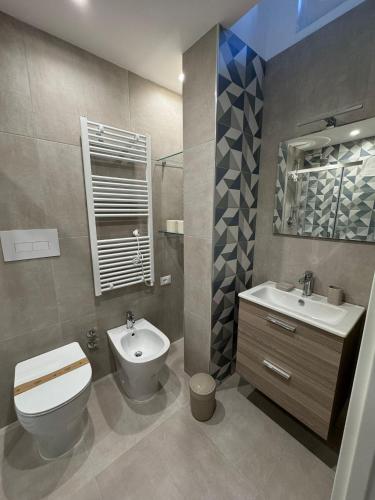a bathroom with a toilet and a bidet and a sink at Moonlight B&B in Canosa di Puglia