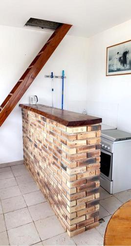 - un mur en briques dans la cuisine équipée d'une cuisinière dans l'établissement Chez Philippe, à Saujon