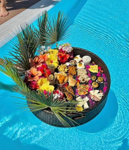 a bowl of food sitting next to a swimming pool at Cuore del Cilento Relais&Retreat in Castellabate