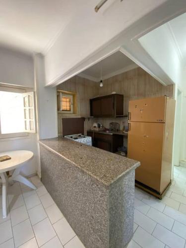 a kitchen with a counter and a yellow refrigerator at شاليه بمساحة خضراء رائعة in Dawwār ‘Abd al Qādir Qāsim