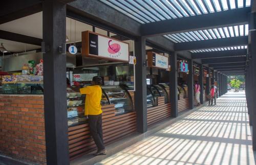 a person standing in the front of a store at Amaze Residence Luxury Room 4 in Boralesgamuwa