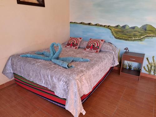 Ένα ή περισσότερα κρεβάτια σε δωμάτιο στο Hostal El Amigo Lucho