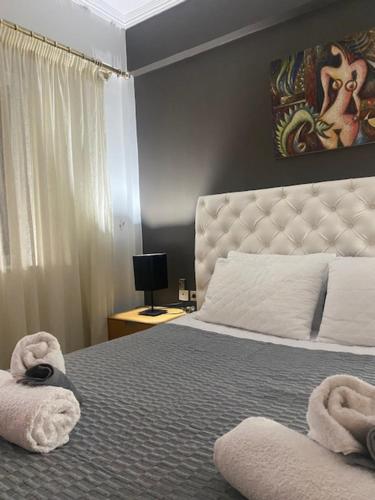 a bedroom with a large bed with towels on it at COTTAGE villa in Káto Panayía