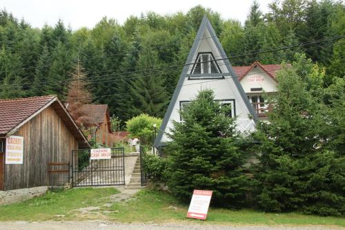 a church with a steeple on the side of a house at Casa Maia in Cîrţişoara