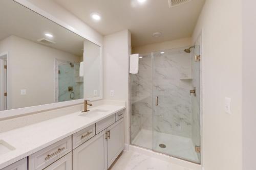 a white bathroom with a shower and a sink at Sea Oaks Village 4 in Berlin