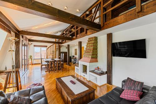 a living room with a couch and a table at Pensiunea Casa Bono in Braşov