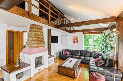 a living room with a couch and a fireplace at Pensiunea Casa Bono - Cazare Brasov in Braşov