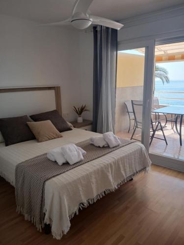 a bedroom with a bed with two towels on it at El espigón de Aguadulce in Aguadulce