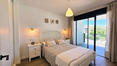 a bedroom with a bed and a large window at Apartamento Mar y Montaña in Barro de Llanes