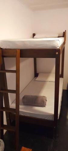 a bunk bed with a pillow on the bottom bunk at Rose Palace in Nuwara Eliya