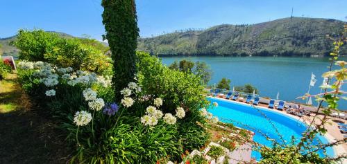 a swimming pool with a view of a lake at Lago Azul Eco Hotel in Ferreira do Zêzere