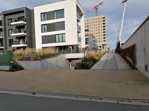 an empty street in front of a building at Bartine - modern and spacious flat near the sea, free parking space in Ostend