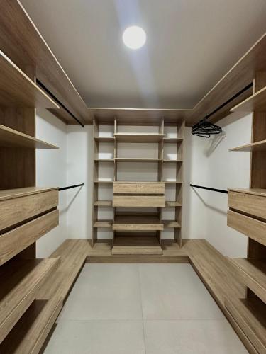 a walk in closet with wooden shelves at Casa Fénix in Marinilla