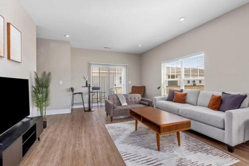 a living room with a couch and a table at Modern 8BR 8BA Condo w Garage and Patio in Wyoming