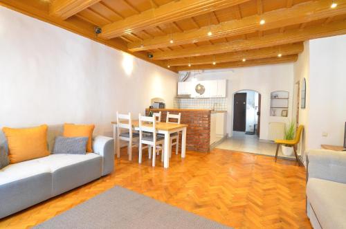 a living room with a couch and a table at Charming Apartment - Heart of Brașov Poarta Schei in Braşov