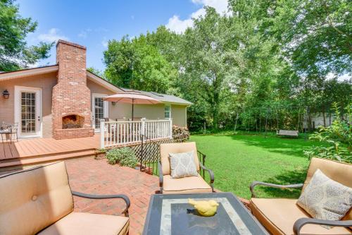 a patio with chairs and an umbrella and a yard at Spacious Taylors Home about 5 Mi to Dtwn Greenville! in Taylors