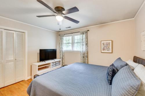 a bedroom with a bed and a flat screen tv at Spacious Taylors Home about 5 Mi to Dtwn Greenville! in Taylors