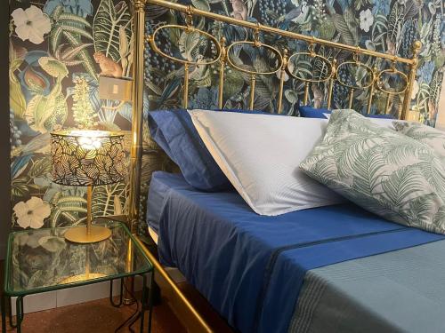 a bedroom with a bed and a side table with a lamp at Design House Monti in Rome