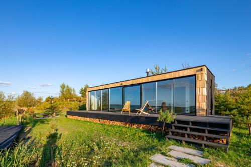 a modern house with glass windows on a field at VyriY House in Lis