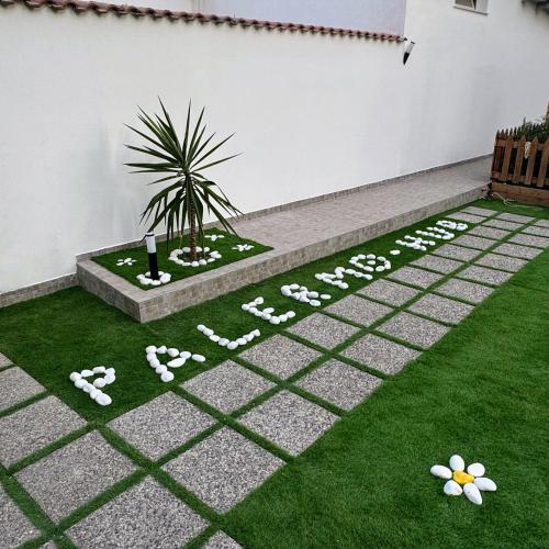 a garden with a sign that says happy anniversary at Palermo Hub in Palermo