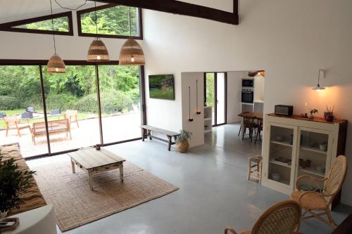 an open living room with a table and chairs at Casa del molí in Sarp