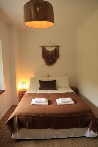 a bedroom with a bed with two towels on it at Casa del molí in Sarp