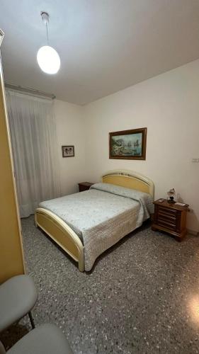 a bedroom with a bed and a table and a lamp at B&B Mamma Mia s in Airola
