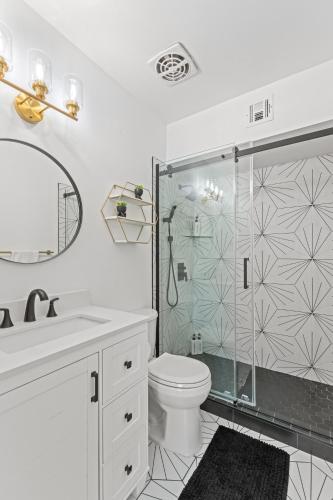 a white bathroom with a shower and a toilet at Windfield Condo In The Entertainment District in Scottsdale